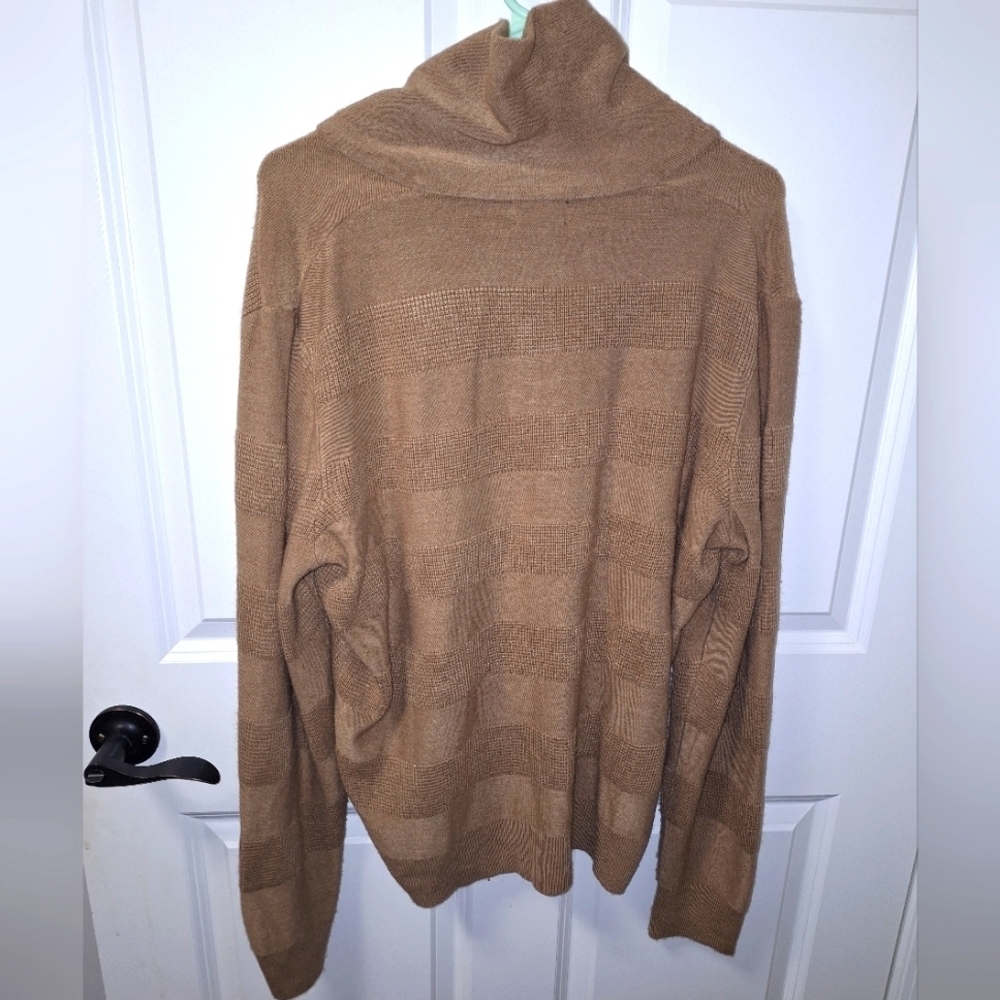 A Geoffrey Beene long sleeve turtleneck sweater in a size large.